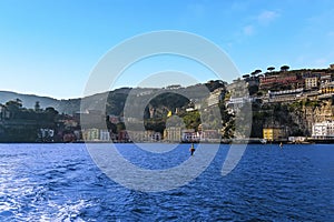 A panorama view looking towards the shore past the harbour wall of the marina Piccola, Sorrento, Italy from a boat heading to