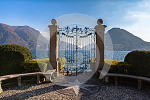 Panorama view of Lugano Lake from gate of Cancello sul Lago di Lugano in Parco Ciani park photo