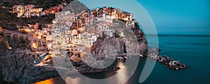 panorama view of Manarola village one of Cinque Terre at night in La Spezia, Italy