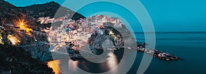 panorama view of Manarola village one of Cinque Terre at night in La Spezia, Italy