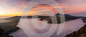 Panorama view of Mount Bromo volcano at sunrise in East Java, Indonesia surrounded by morning fog