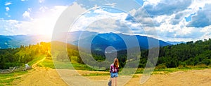 Panorama view of mountains. Girl in mountains. Hipster travelling. Beautiful landscape. Sky with clouds. Amazing nature.