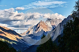 Panorama view of mountains snowy peaks cloudy sky