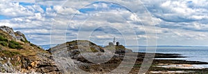 Panorama view of the Mumbles headland with the historic lighthouse in Swansea Bay