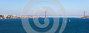 Panorama view over the 25 de Abril Bridge. The bridge is connecting the city of Lisbon to the municipality of Almada