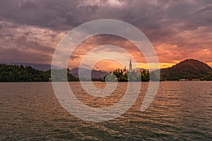 Panorama view over lake bled with island and church during sunset with the alps in the background, Slovenia, Europe