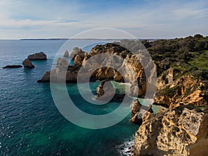 Panorama view of Praia do Submarino Algarve cliff coast sand beach holiday vacation spot in Portimao Portugal Europe photo