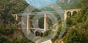 Panorama view of Railroad bridge Pont du Vecchio, between hills near Vivaro, Corsica, France.