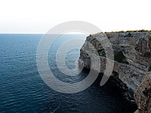 Panorama view of rocky cliff coast shore turquoise mediterranean sea water Cala Llombards Mallorca Balearic Spain