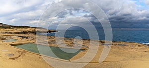 panorama view of the salt pans in Xwejni Bay on the Maltese island of Gozo