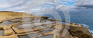 panorama view of the salt pans in Xwejni Bay on the Maltese island of Gozo