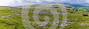 A panorama view showing glacial erratics deposited on the limestone pavement on the southern slopes of Ingleborough, Yorkshire UK photo