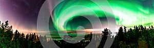 Panorama view of Strong Northern Lights and atmospheric phenomenon `STEVE` meets Milky Way. Steve appears as a purple and green photo