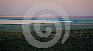 Panorama view to Aral sea from the rim of Plateau Ustyurt near Aktumsuk cape at sunset, Karakalpakstan, Uzbekistan