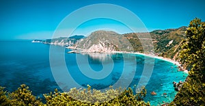 Panorama View to Petani beach with transparent and crystal clear blue mediterranean sea water in picturesque bay, Kefalonia island