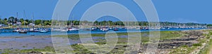 A panorama view towards moorings at low tide on the River Hamble