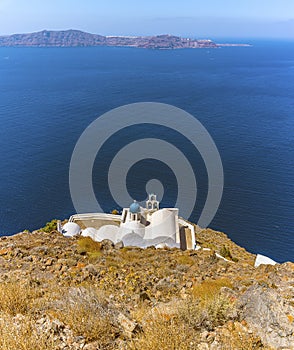 A panorama view of a traditional greek church below Skaros Rock