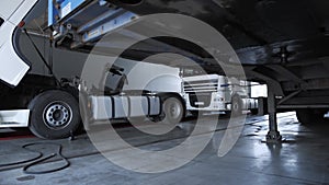 Panorama view on a white trucks and refrigerator at the lorry service station