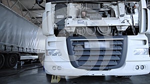 Panorama view on a white trucks and refrigerator at the lorry service station