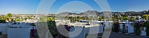 Panorama of the village of Gumbet white houses and crashes and a mountain in the background