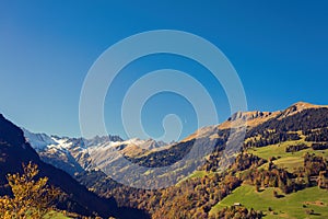 Panorama of the village of VÃÂ¤ttis and bridge against the background of the Swiss Alps at sunset. St. Gallen, Switzerland.