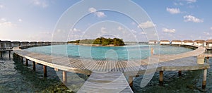 Panorama of water bungalows in hotel on Maldives. Villas on Indian ocean at luxury spa resort.