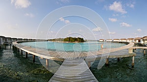 Panorama of water bungalows in hotel on Maldives. Villas on Indian ocean at luxury spa resort.