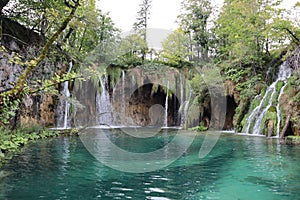 Panorama of the waterfall, lake with azure water in an autumn day, Plitvice Lakes National Park