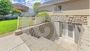 Panorama Whispy white clouds Basement entrance with glass panels on the double doors