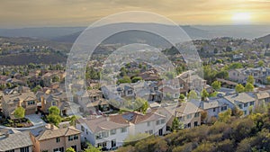 Panorama Whispy white clouds Residential area with cul-de-sac near the bottom of the slope ne