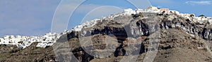 Panorama of white buildings lining the caldera crater photo