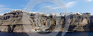 Panorama of white buildings lining the caldera crater photo
