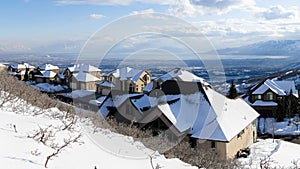 Panorama White puffy clouds High angle view of a residential area covered with snow at Draper, Utah