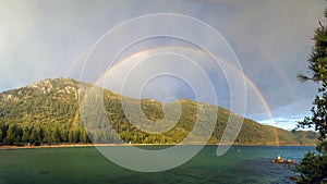 Panorama wide view of colorful double rainbow on Sand Harbor at Lake Tahoe Nevada
