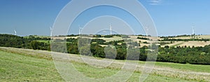 Panorama of windfarm over a hill