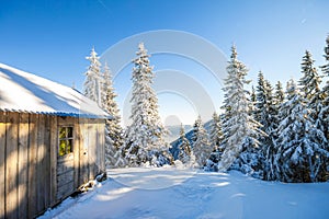 Panorama of winter mountains with houses of shepherds. Carpathians, Ukraine, Europe. Fantastic winter landscape. Creative