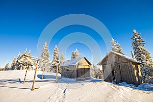 Panorama of winter mountains with houses of shepherds. Carpathians, Ukraine, Europe. Fantastic winter landscape. Creative