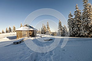 Panorama of winter mountains with houses of shepherds. Carpathians, Ukraine, Europe. Fantastic winter landscape. Creative