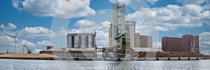 Panorama of wood processing factory with machines and trucks