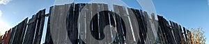 Panorama of a wooden fence running into infinity.