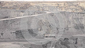 panorama of a working coal open pit (rigs and trucks)