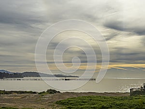 Panorama, Yellow patches in gray clouds over Goleta pier, CA, USA