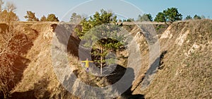 Panorama of young successful woman hiker silhouette with open arms on morning mountain peak. Panoramic view of tourist