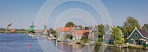 Panorama of the Zaan river with historical houses and windmills photo