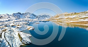 The panoramaic aerial image of the first snow falls on the Tannensee Lake