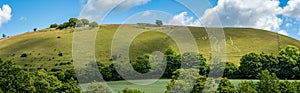 Panoramatic view of a hillside with The Cerne Abbas Giant, an ancient hill figure near the village of Cerne Abbas in Dorset, Engla