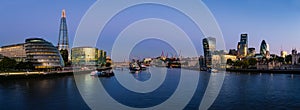 Panoramatic view of Thames river with modern London cityscape photo