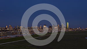 Panoramic aerial drone picture of Dallas skyline and Trammel Crow Park at sunset in winter