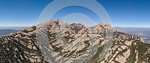 Panoramic aerial drone shot of Top of Montserrat mountain range in morning time near Barcelona