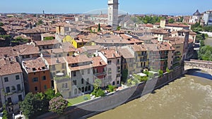 Panoramic aerial drone view of Verona, Italy. The drone is spinning over the river Adige, the typical Italian apartment rooftops